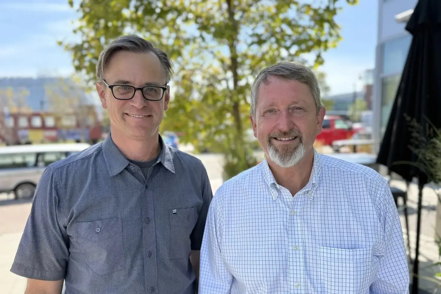 The two co-founders of Solen Works standing together outdoors on a sunny day in Portland, Maine.